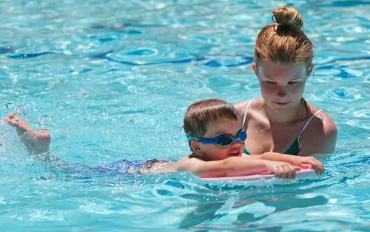 a person and a child in a pool