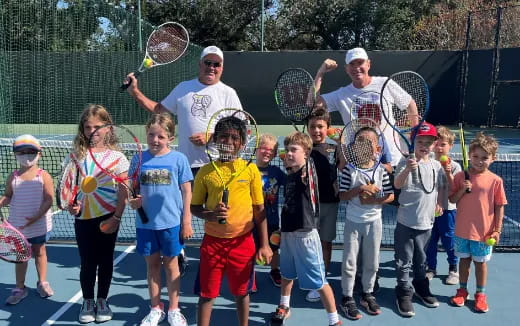 a group of people holding tennis rackets