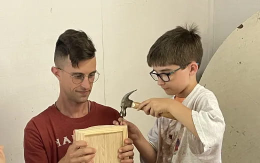 a couple of boys holding a bird