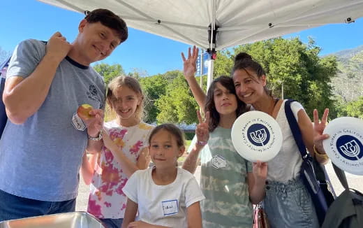 a group of people holding frisbees