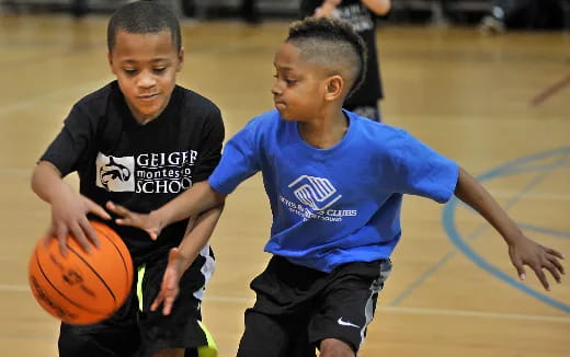 a couple of boys playing basketball