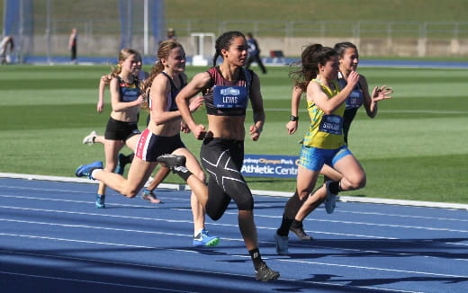 a group of women running on a track