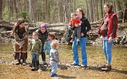 a group of people standing in a forest