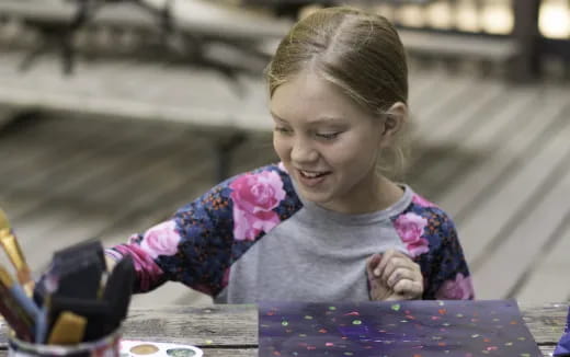 a girl sitting at a table