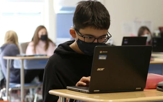 a boy using a laptop