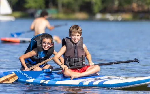 a couple of boys in a canoe