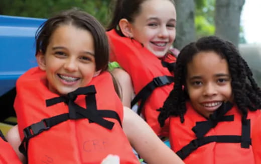 a group of women wearing life jackets