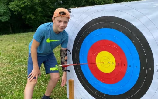 a man standing next to a target
