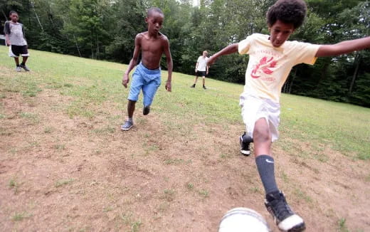 a group of boys playing frisbee