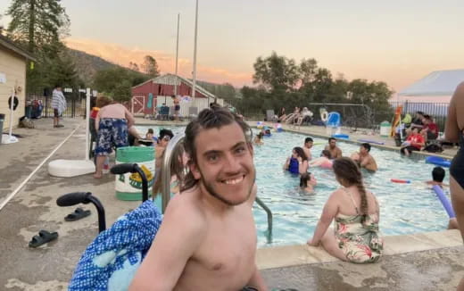 a person smiling in a pool