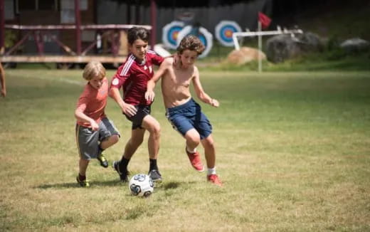 a group of kids playing football