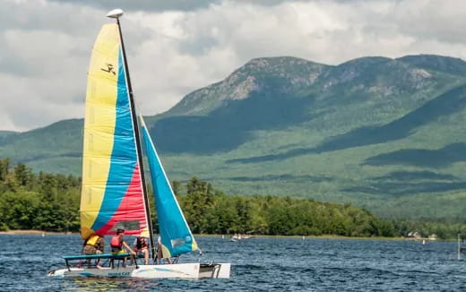 a group of people on a sailboat in the water