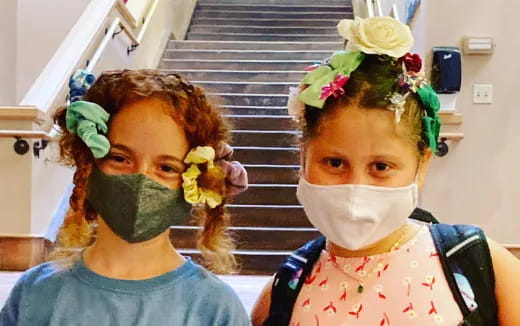 a couple of girls wearing face masks