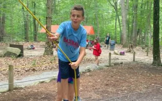 a boy holding a bow and arrow