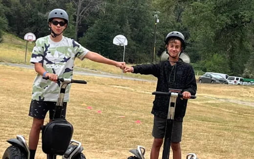 a couple of people on scooters posing for the camera