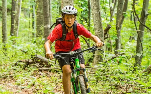 a man riding a bike through the woods