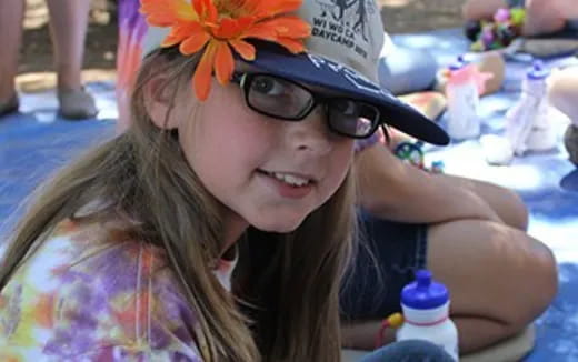 a girl wearing sunglasses and a flower crown
