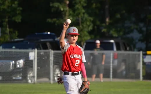 a kid throwing a baseball