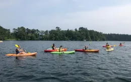 a group of people in canoes on a lake