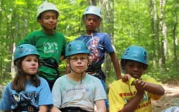 a group of kids wearing helmets