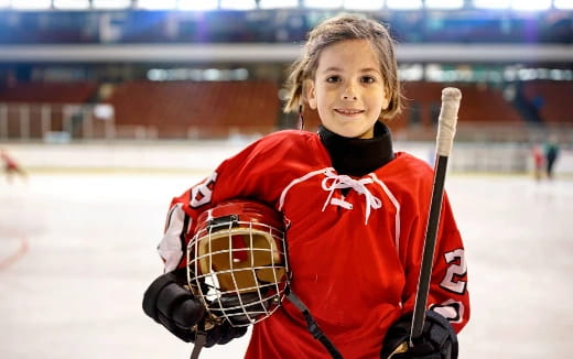 a girl holding a hockey stick
