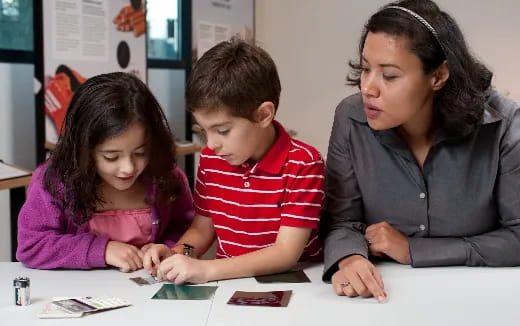 a person and a child looking at a book