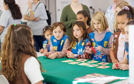 a group of children sitting at a table