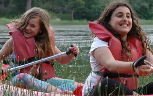 a couple of girls on a boat