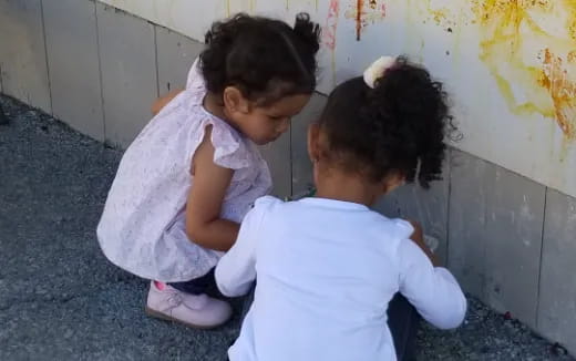 a couple of children sitting on the floor