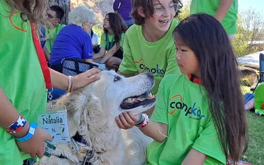 a group of people petting a dog