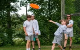 a group of men playing frisbee