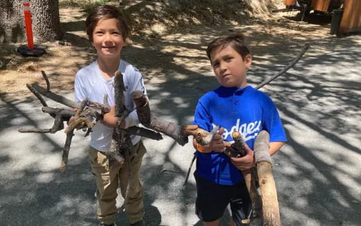 two boys holding a snake