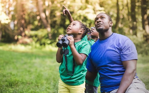 a man and a woman taking a picture in a park