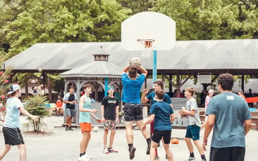 a group of people playing basketball