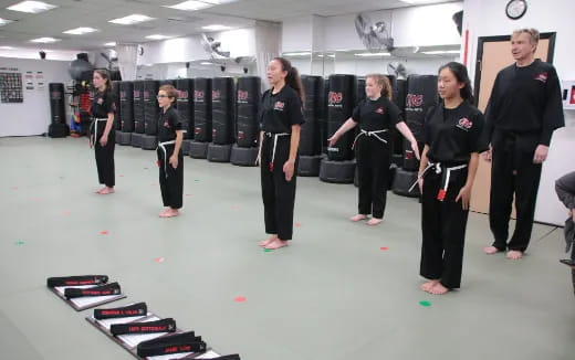a group of people in black karate uniforms