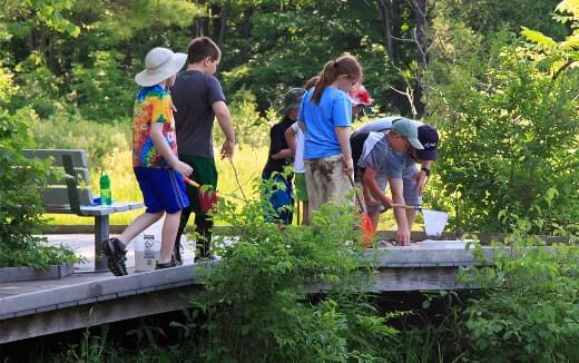 a group of people standing on a bridge over a river