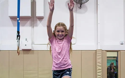 a girl holding her arms up