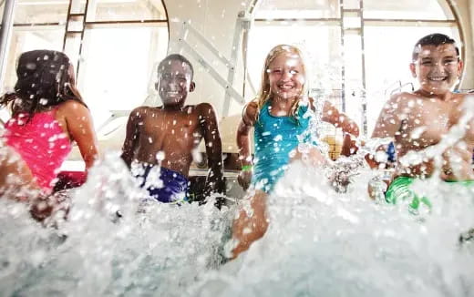 a group of children playing in the water