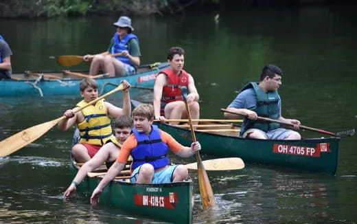 a group of people in canoes