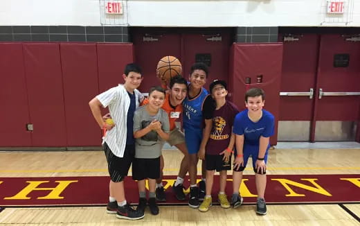 a group of boys posing for a picture with a basketball