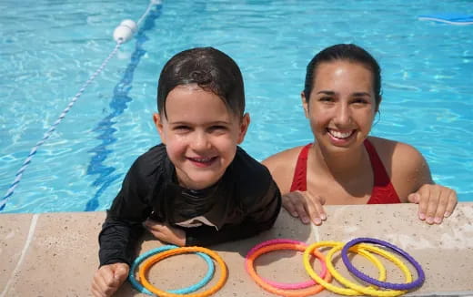 a boy and girl in a pool