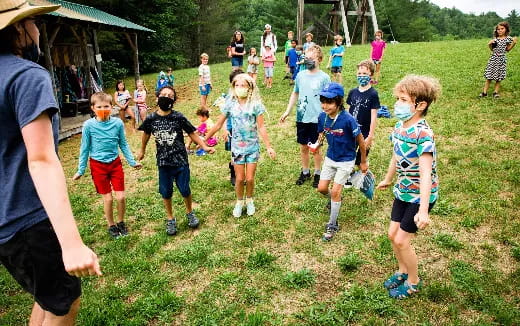 a group of children playing in a field