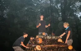 a group of men around a campfire