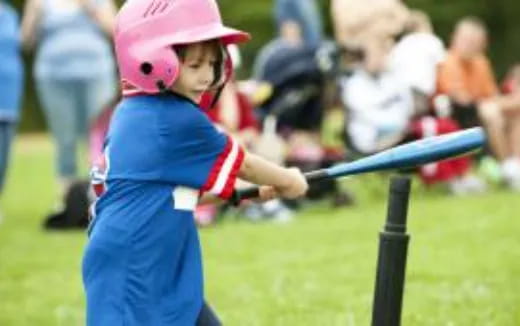 a young girl playing baseball