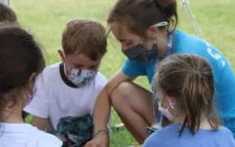 a group of children sitting in a circle