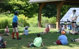 a group of people sitting on the grass