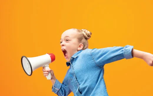 a child yelling into a megaphone