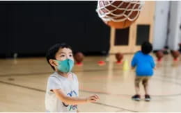 a child holding a ball