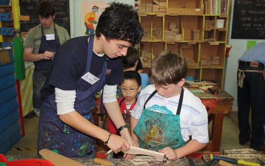 a person showing a boy something on a paper