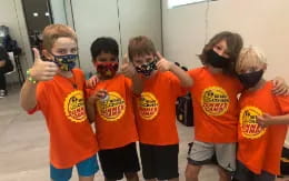 a group of kids wearing face masks